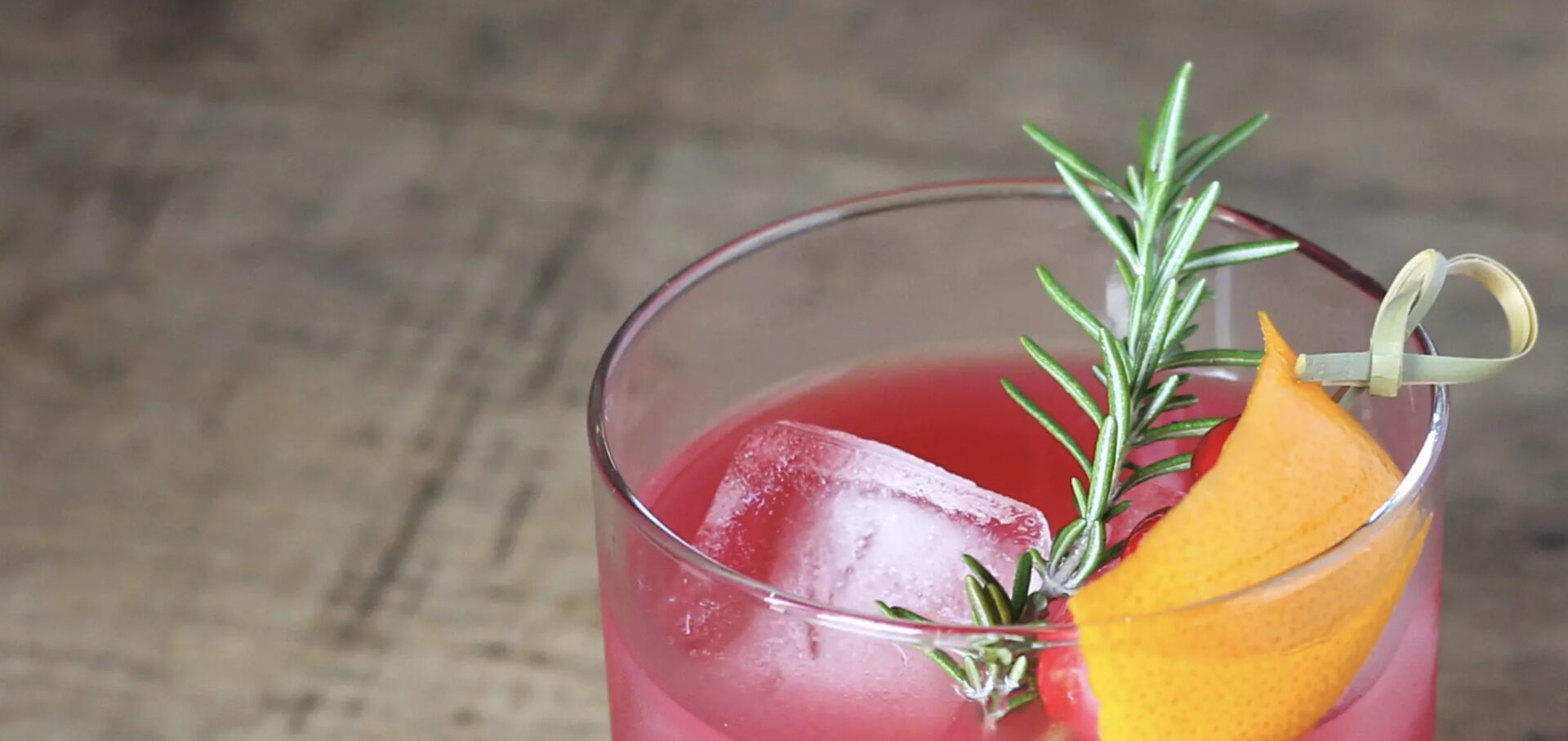 cranberries gin smash with a rosemary garnish 